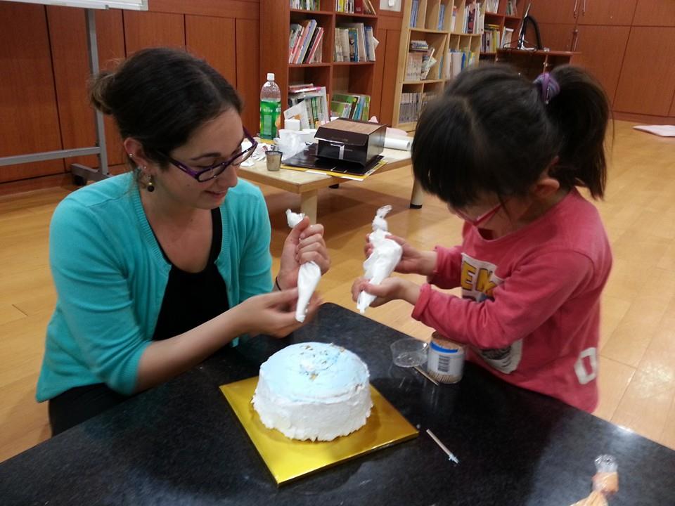 Volunteering at orphanage teaching kids to make cakes