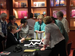 Cynthia Sears presents some of the books from the Museums Collection to members of the Puget Sound Book Artists. 