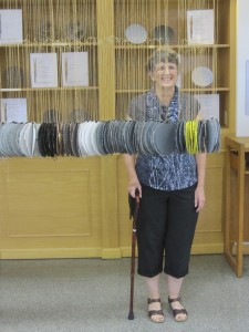 Curator Lucia Harrison stands with her work, Ancient Forests of Frying Pan Creek at Collins Library  