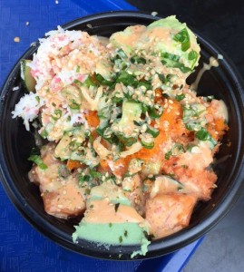This bowl has salmon, crab, spicy mayo, sesame seeds, green onions and fish eggs on sushi rice